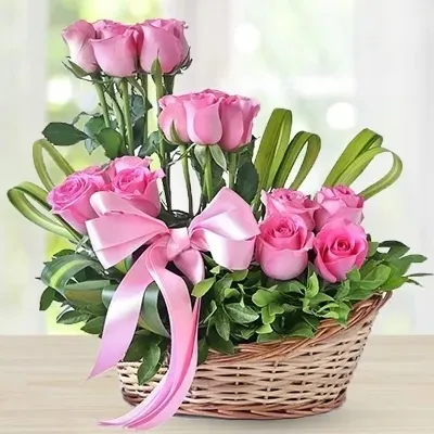 24 pink roses paired with fresh green leaves.