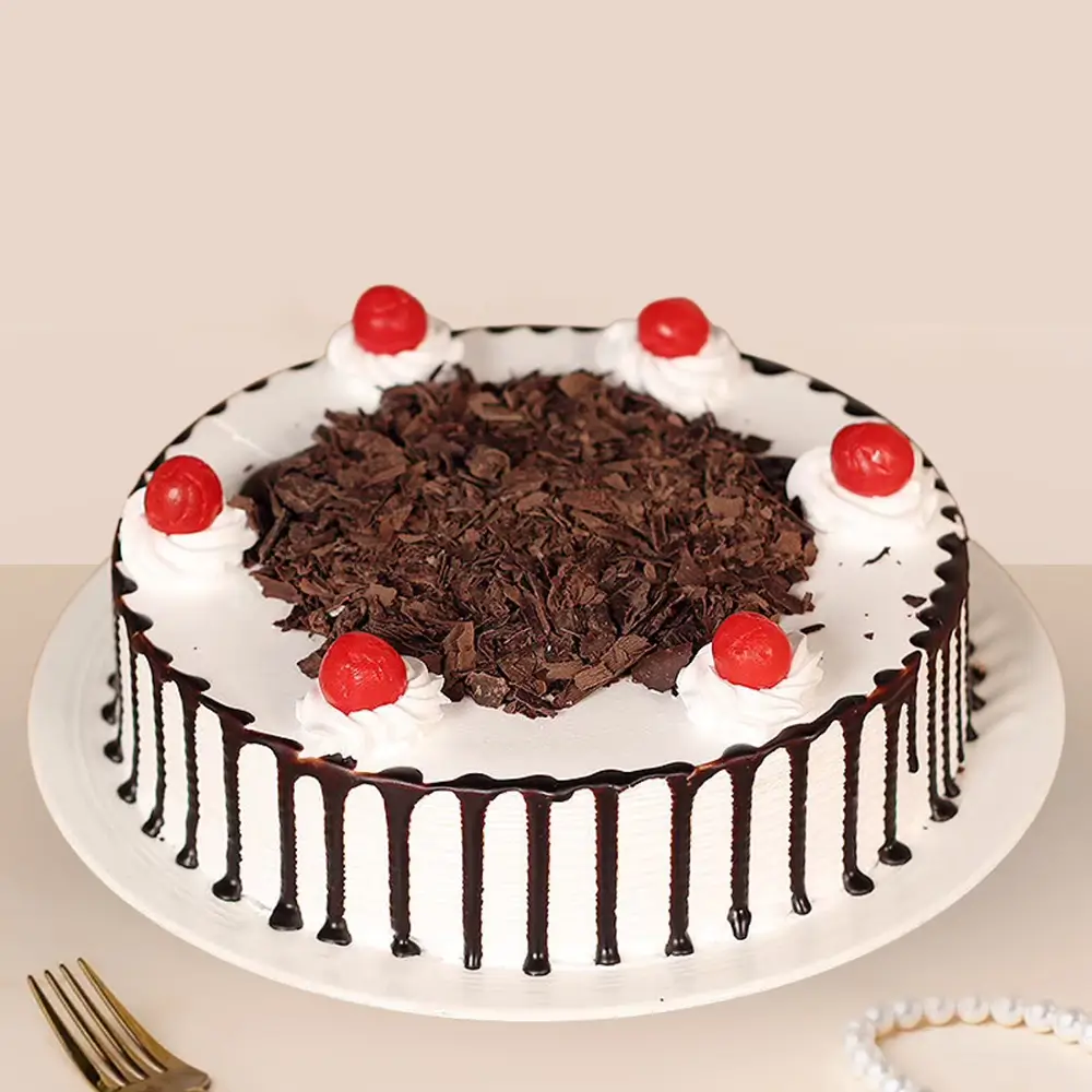 1 kg round black forest cake with chocolate dripping in parellel lines from the sides