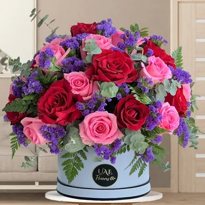 10 red rose, 15 pink roses, with purple statice & green fillers in a white round box