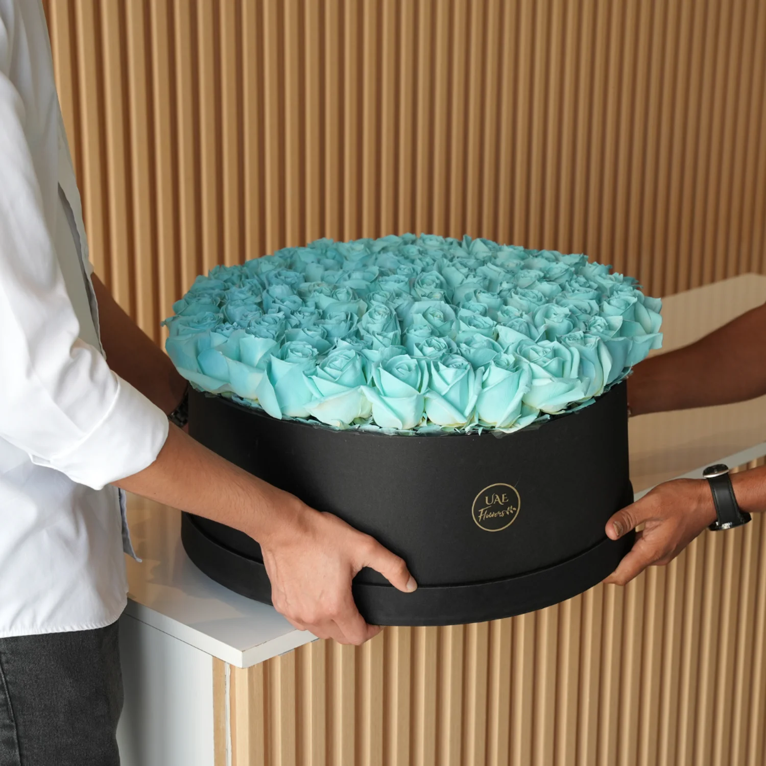 120 sprayed blue roses in a white round box