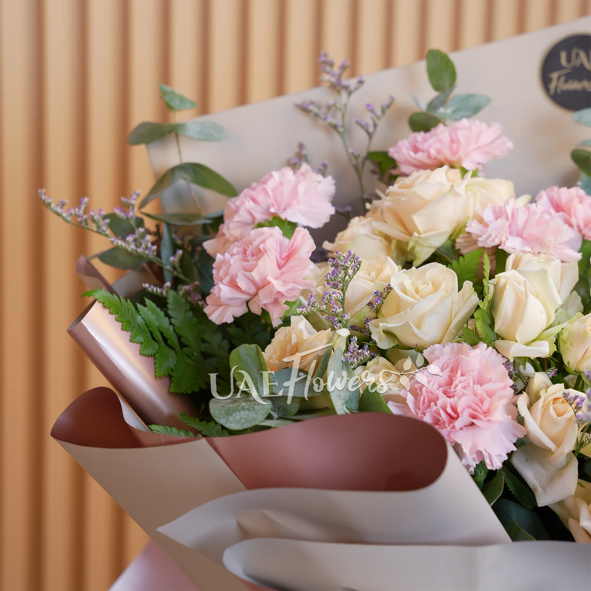 bouquet with 8 soft pink carnations and 5 peach spray roses