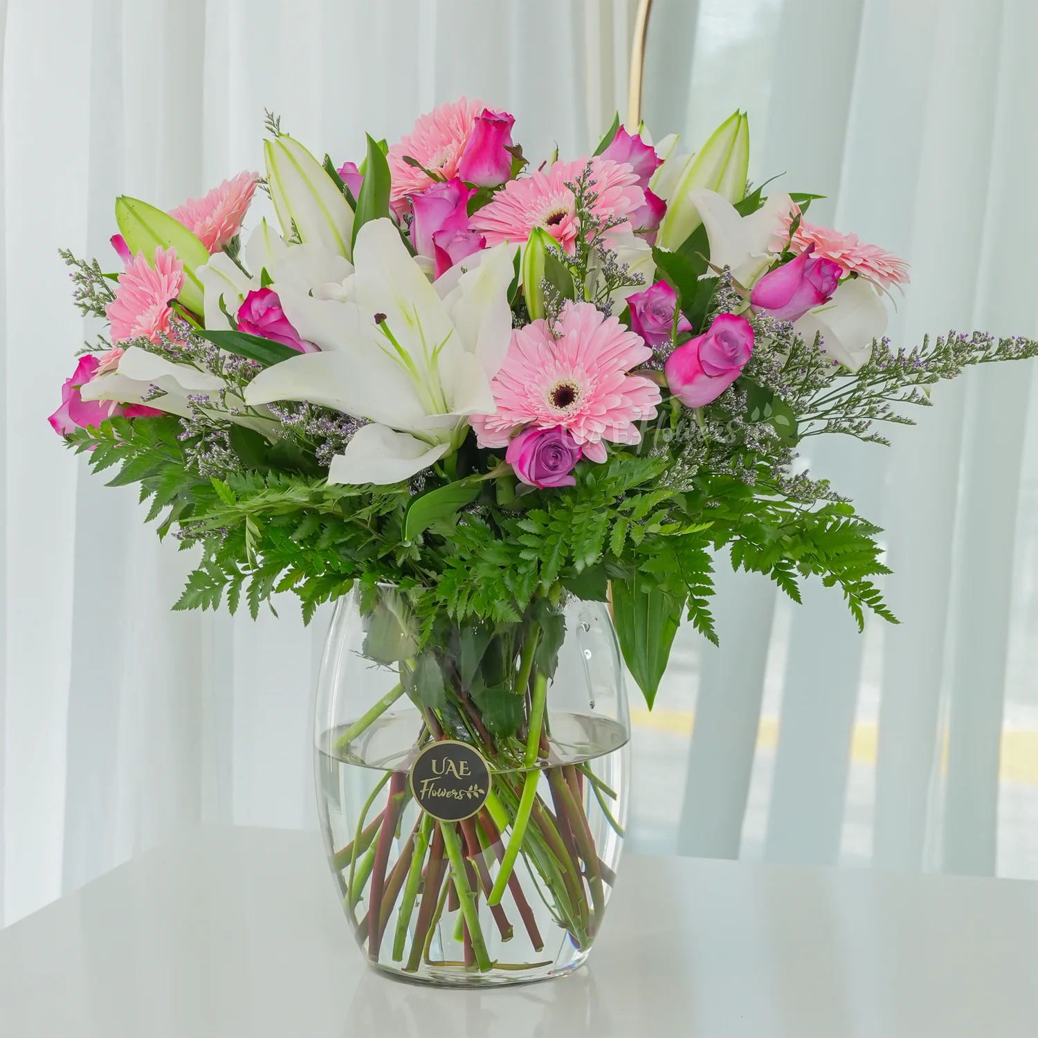 15 purple roses, 6 pink gerberas, and 3 white lilies