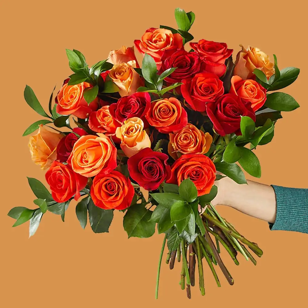 A bouquet of 25 red, orange & peach roses with green fillers tied with ribbon