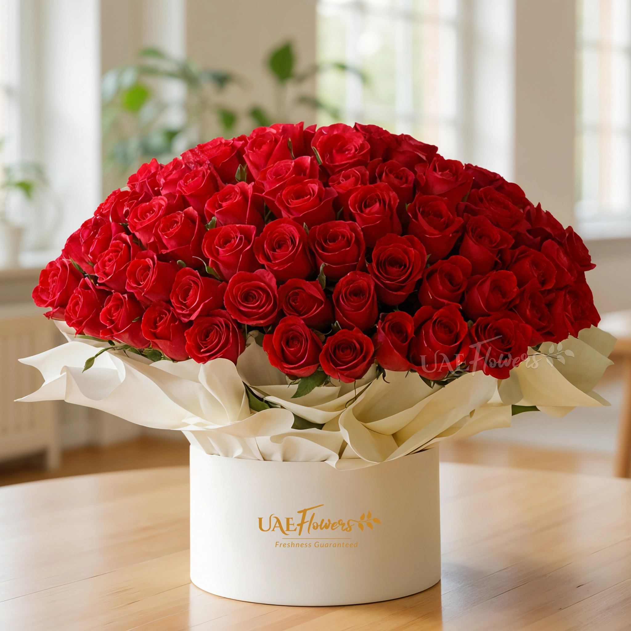 100 red roses arranged in a premium box with paper wrap