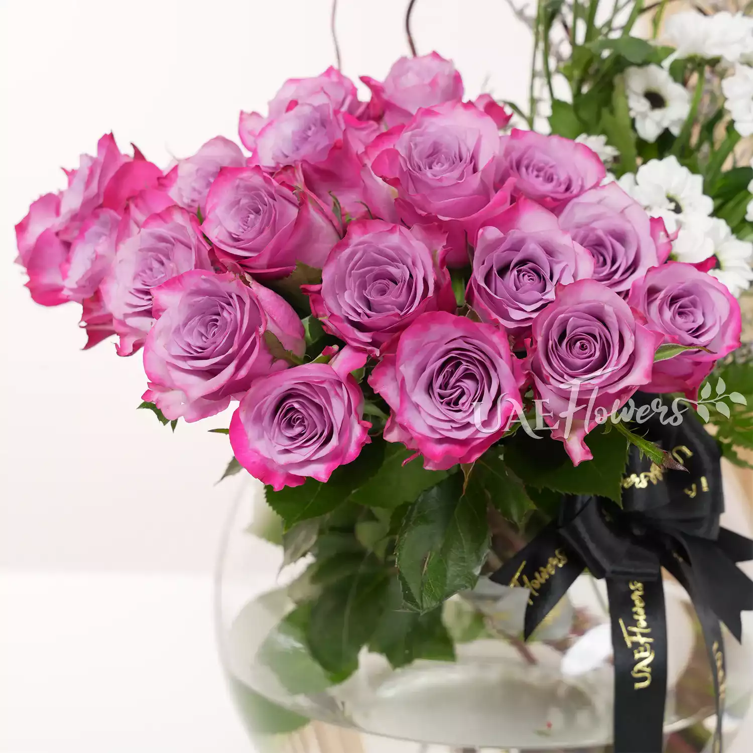 purple roses and white chrysanthemums, accented with lush green fillers