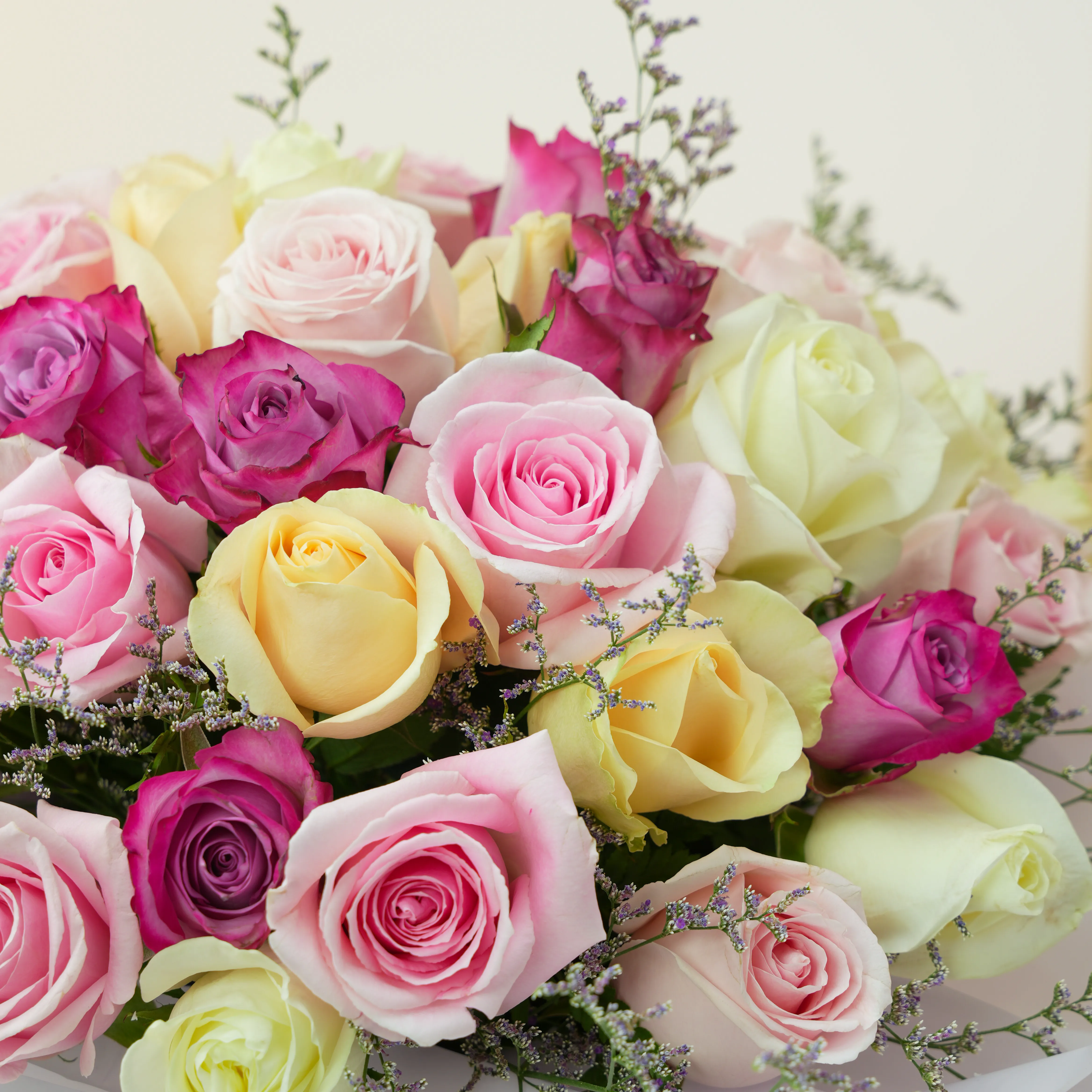 box of 30 roses in purple, pink, peach and white shades