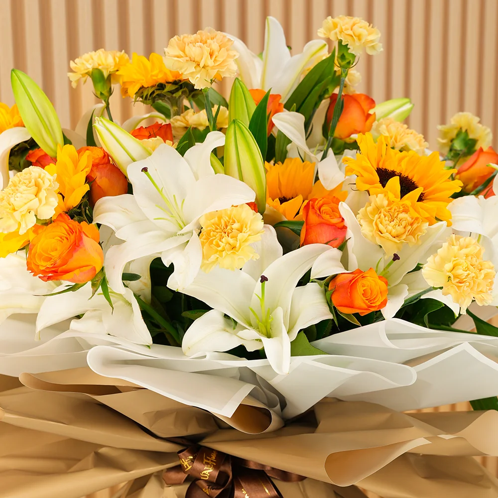 5 white lilies, 5 sunflowers, 10 orange roses, and 15 peach carnations