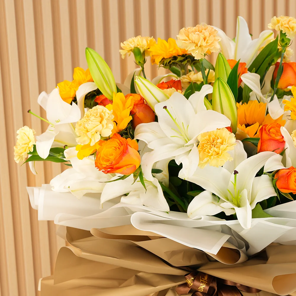 5 white lilies, 5 sunflowers, 10 orange roses, and 15 peach carnations