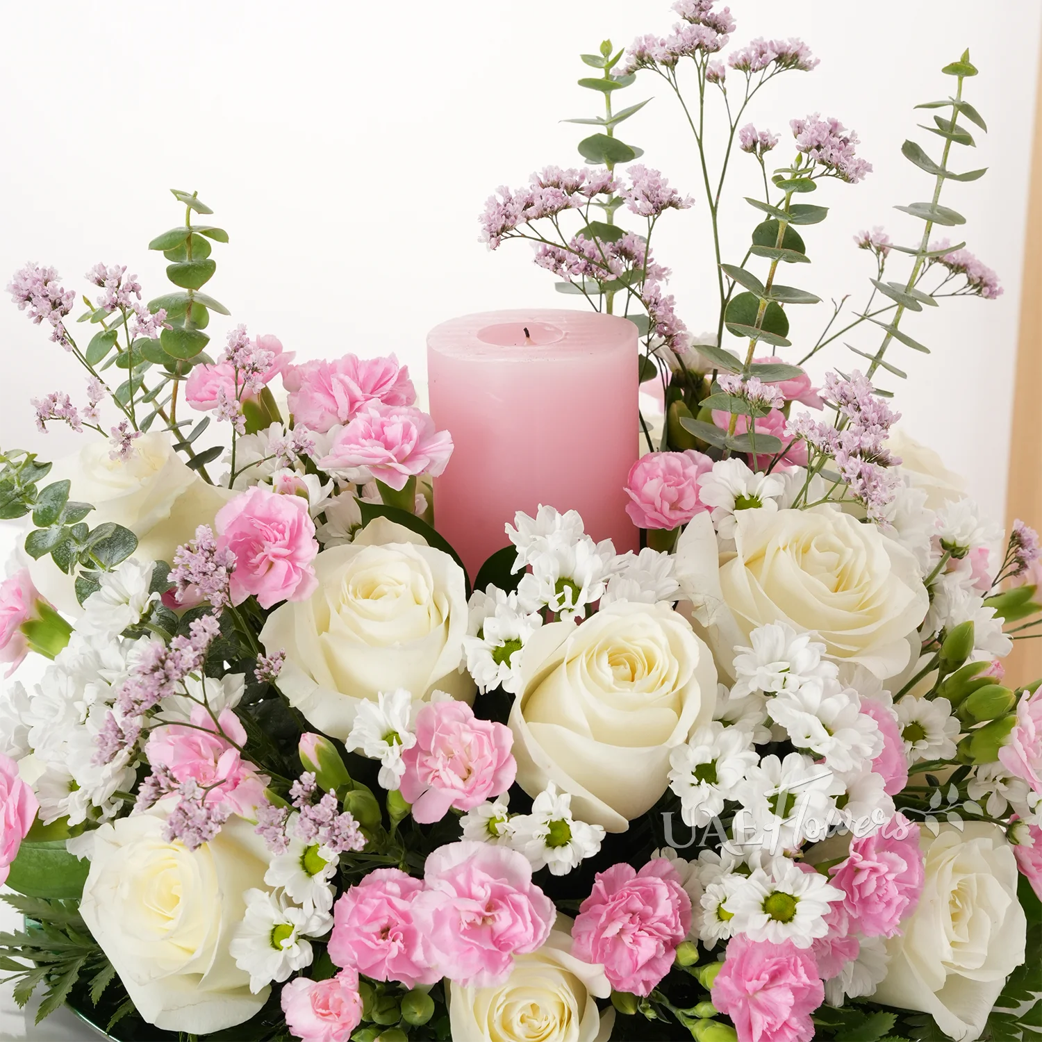 15 white roses, 5 chrysanthemums, 10 pink carnations, and pink candle