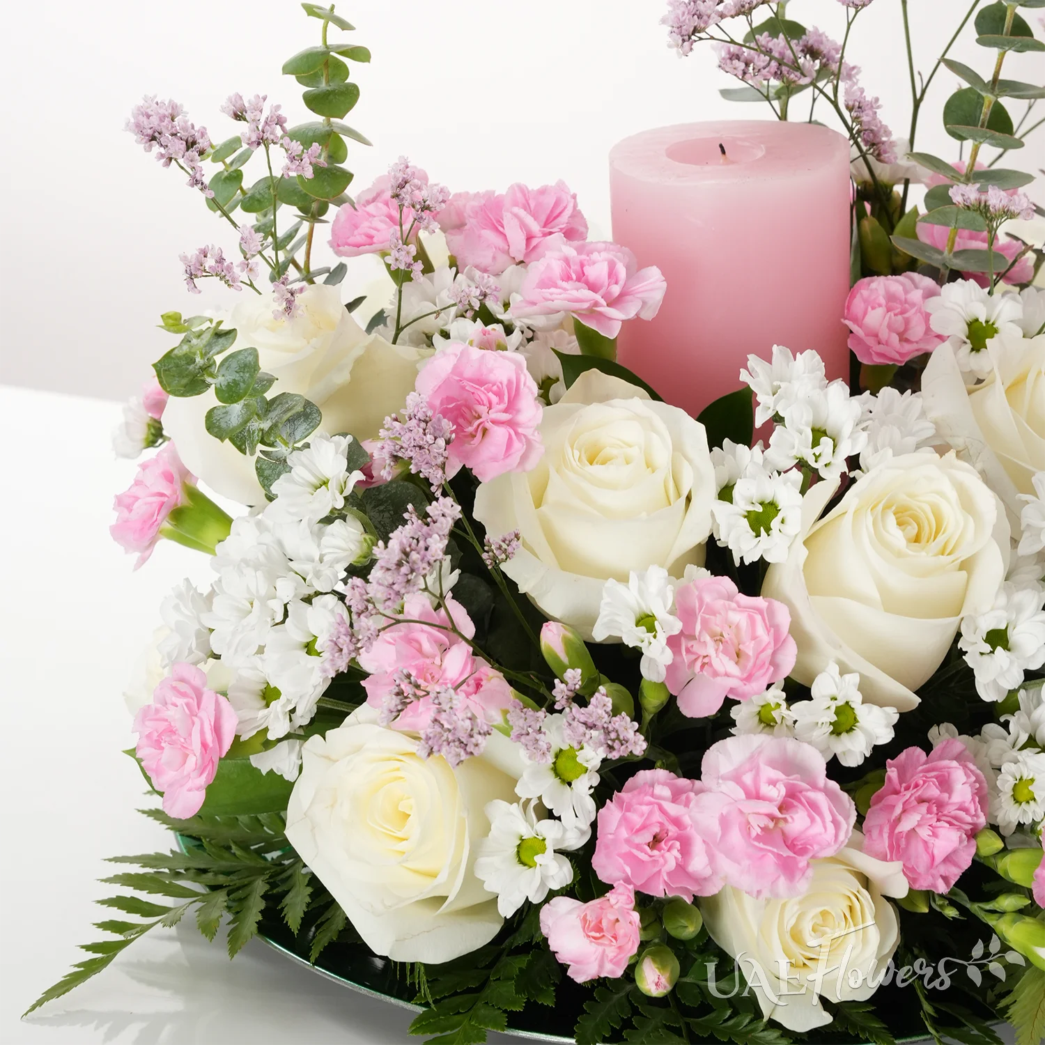 15 white roses, 5 chrysanthemums, 10 pink carnations, and pink candle